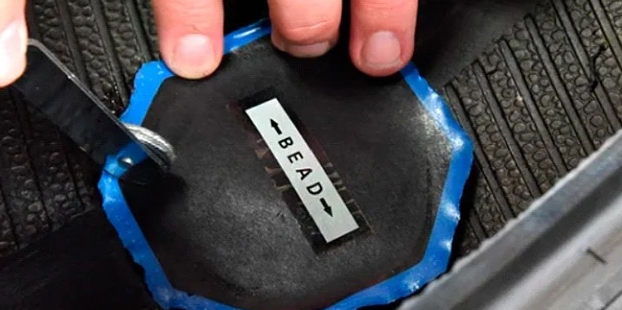 Mobile tire repair service fixing a flat tire with plug and patch in Jacksonville Florida.