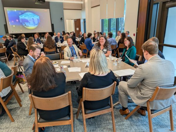 Inn members seated at tables during the inaugural orientation meeting.