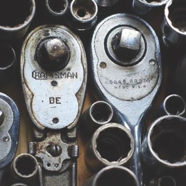 Close-up of vintage ratchet wrenches and sockets.