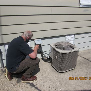 John Richter inspecting A/C unit