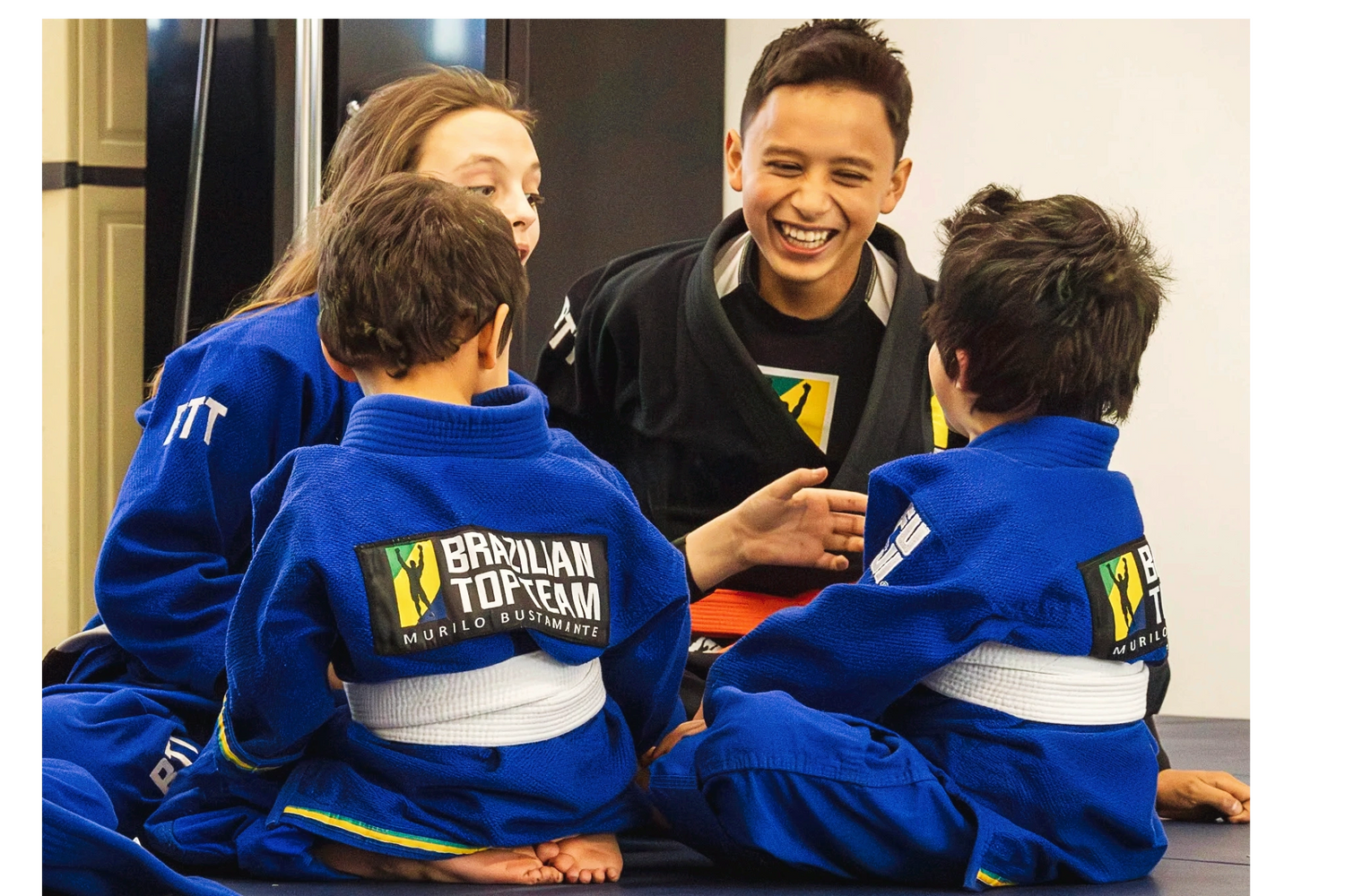 Woman practicing headstand yoga on a mat outdoors with a tropical view.