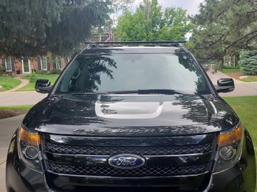 Front view of a black Ford Explorer parked on a driveway.