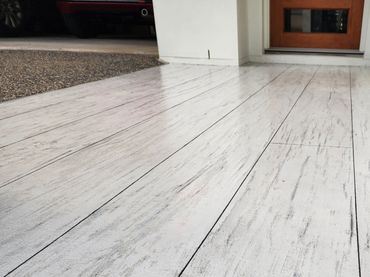 Patio resurfaced with Concrete Timber Look  Overlay  flooring by Spray Pave Wide Bay.