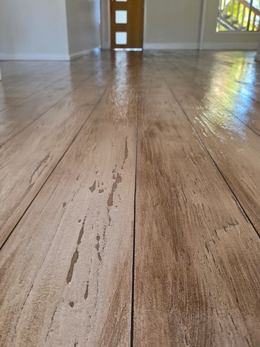 Tiled Internal flooring recoated with Concrete Timber Look Overlay flooring by Spray Pave Wide Bay.