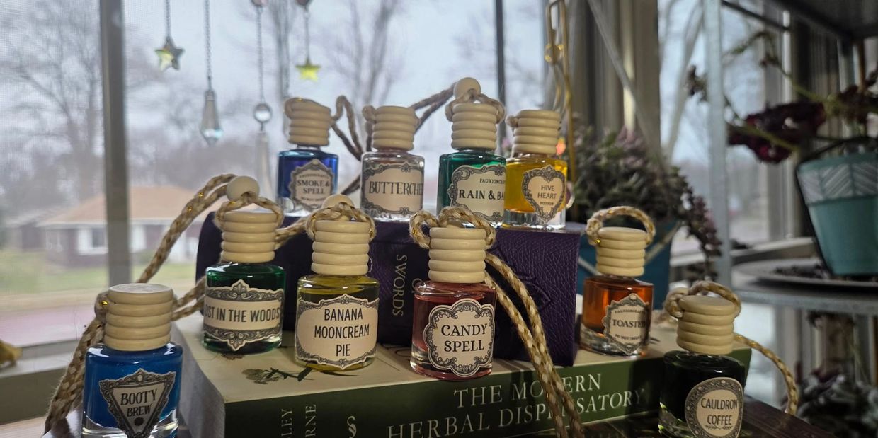 Various small potion bottles with labels displayed on books.