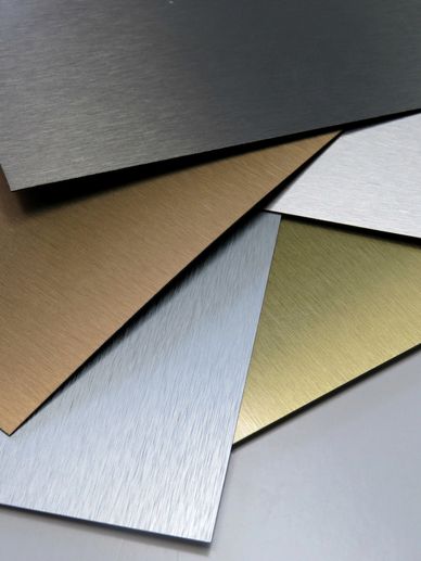 Various brushed metal sheets in different colors and finishes.
