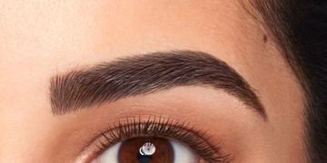 Close-up of a well-groomed eyebrow and brown eye.