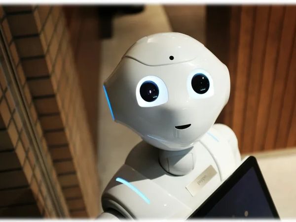 Happy robot lookin up and smiling