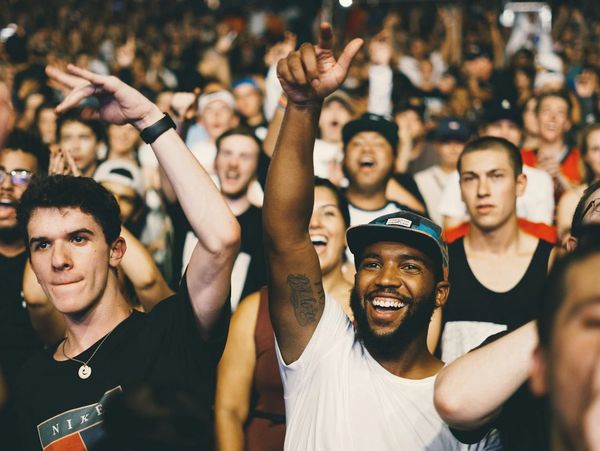 Crowd with hands in air, happy smiles everywhere