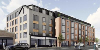Modern mixed-use building with shops and apartments on a city street.