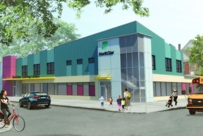 Modern NorthStar community center with people and vehicles nearby.
