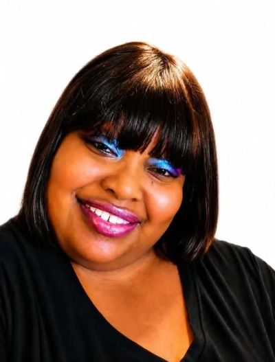 Smiling woman with vibrant makeup and straight hair.