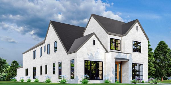 Modern white brick house with large windows and black roof under blue sky.