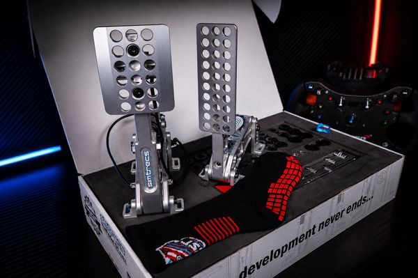 Sim Racing pedals with a gaming controller in the background.