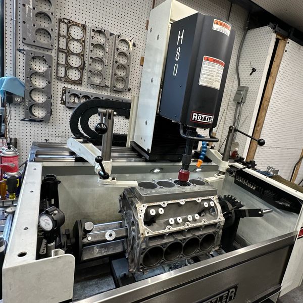 Precision engine block machining on a Rottler H80 machine in a workshop.