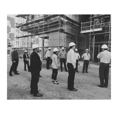 Group of professionals wearing hard hats at a construction site.