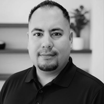 Black and white portrait of a man with short hair and goatee.