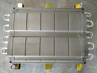 Metal industrial panel with handles on a concrete floor.
