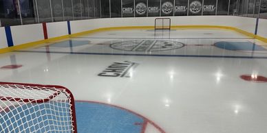 Empty ice hockey rink with clear lines and goals.