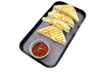 Grilled cheese sandwiches served with ketchup on a tray.