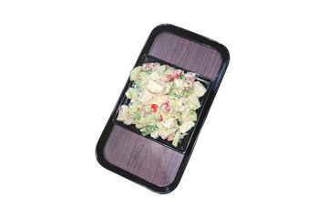 A fresh tofu salad with vegetables in a black bowl on a tray.
