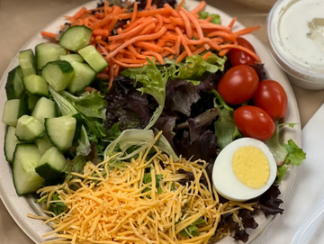garden salad with diced cucumber, tomato, shredded cheddar cheese and shredded carrot