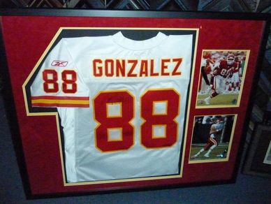 Framed football jersey with number 88 and two action photos.