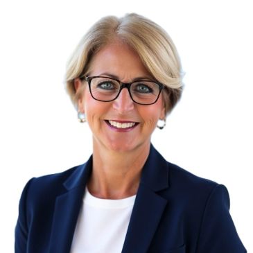 Professional middle-aged woman with glasses smiling confidently in business attire.