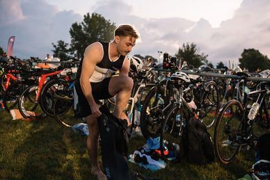 Tri CLE participant putting on wetsuit in the transition area at Edgewater Park.