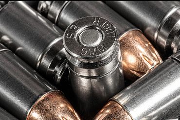 Close-up of metallic bullet casings in pattern.