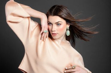 Woman in beige top with jewelry – polished editorial portrait