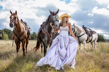 Woman in gown with horses – high-end lifestyle editorial