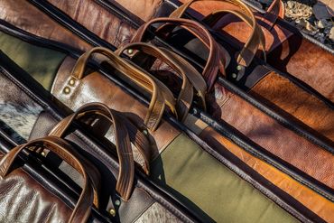 Stacked leather cases and straps in warm studio light.