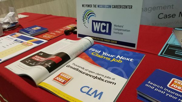 Career and job search materials for claims jobs on a red table.