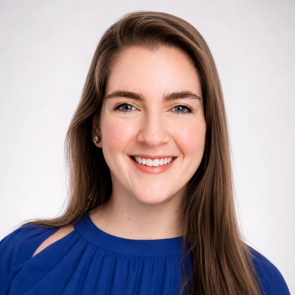 Smiling woman in blue dress.