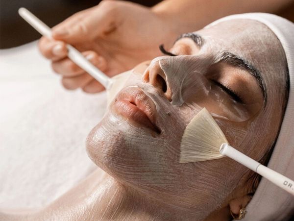 Hydrating facial mask applied by esthetician for glowing and refreshed skin