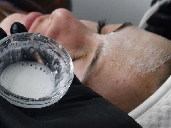 Esthetician preparing and applying chemical peel