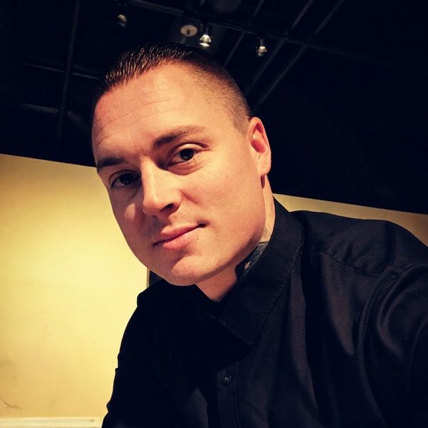 Man in black shirt looking at the camera.