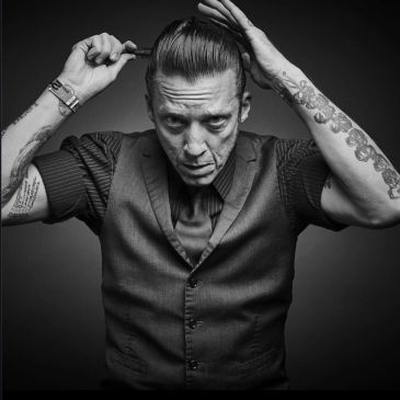 Man styling his hair with a comb.