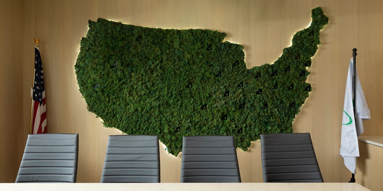 Conference room with a green moss map of the USA and flags.