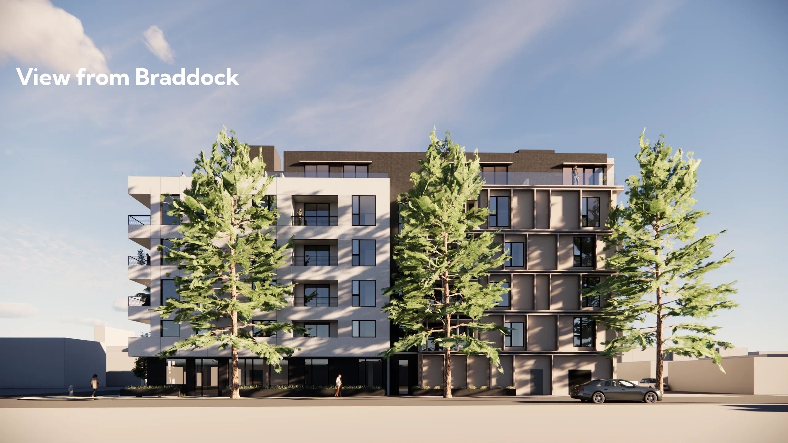 Modern residential building with large trees in front under a clear sky.