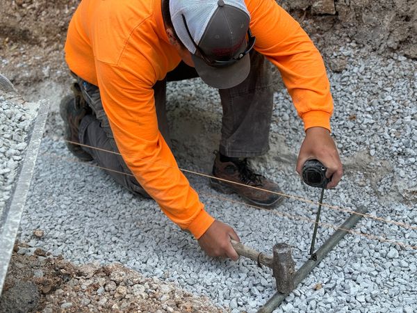 Teammate, measuring the screening pipes, so that the foundation is solid and level
