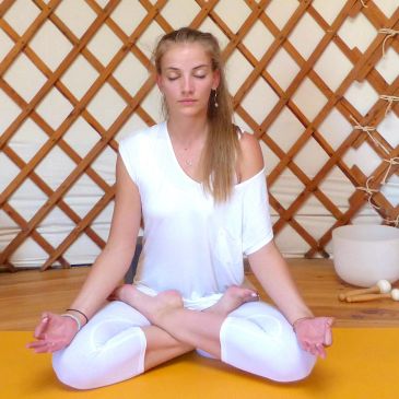 Woman meditating in yoga pose.