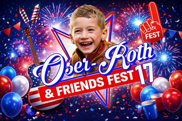 Cheerful boy at Osei-Roth &amp; Friends Fest 17 with fireworks and festive decorations.