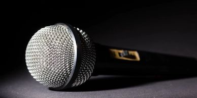 Close-up of a microphone on a dark surface.