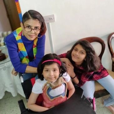Three people posing happily indoors.