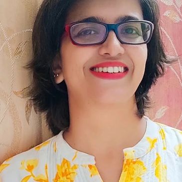 Smiling woman with glasses and red lipstick.