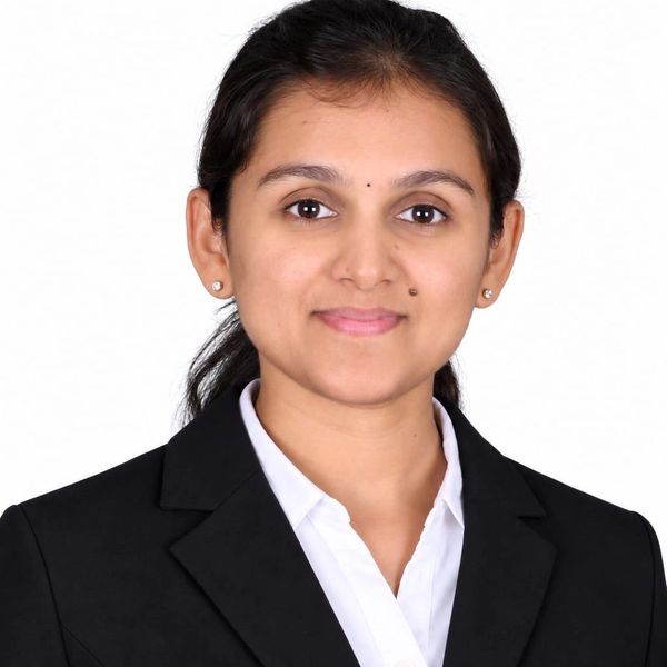 Professional woman in black blazer and white shirt.