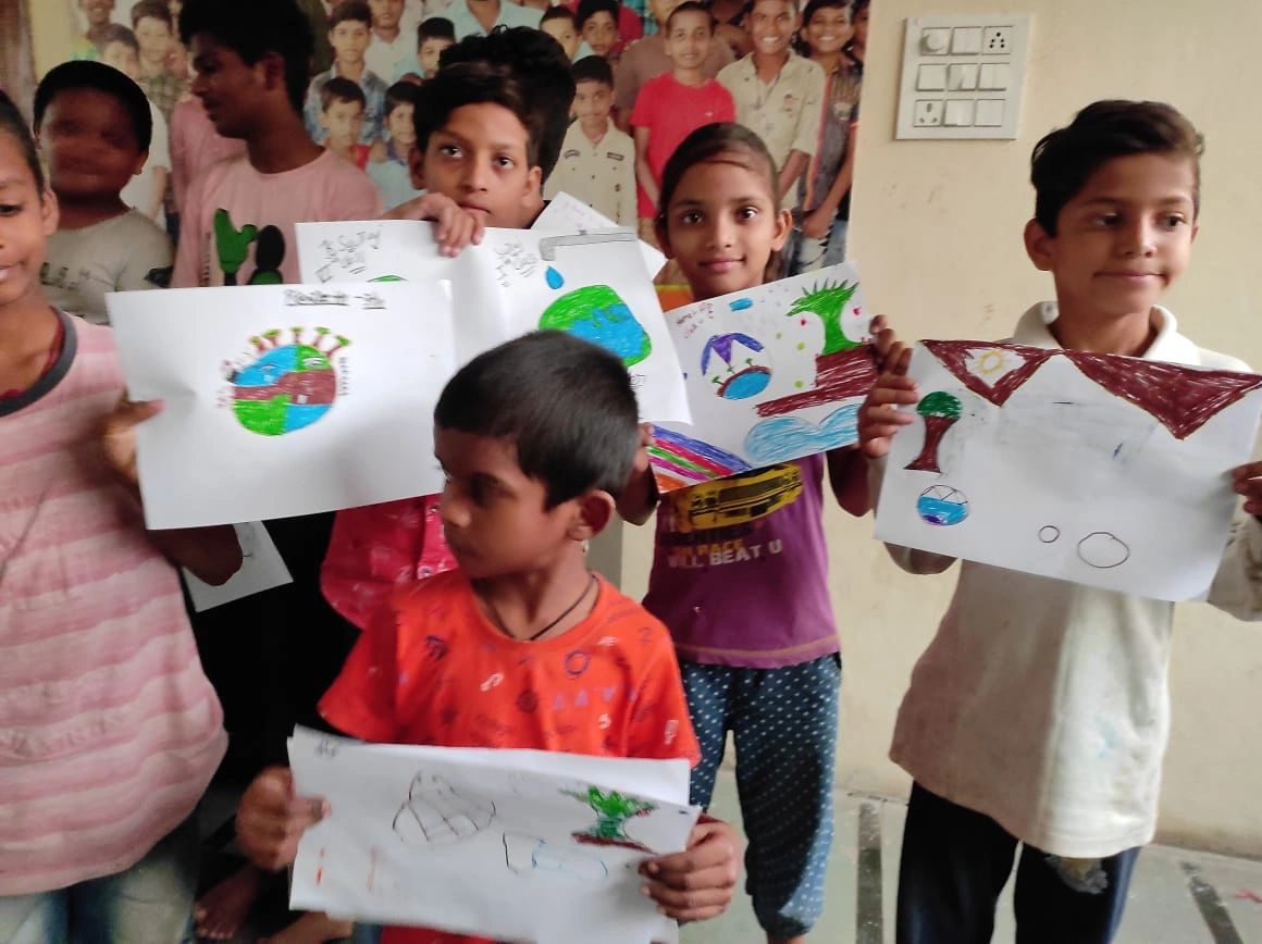 Children showing their colorful drawings.