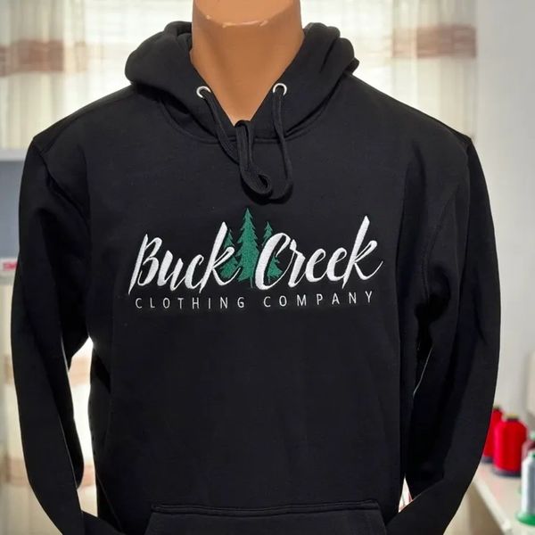 Black hoodie with Buck Creek Clothing Company logo and tree design on a mannequin.